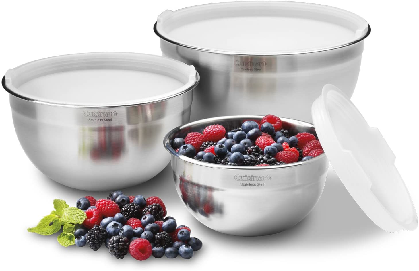 Three stainless steel mixing bowls with lids, one with berries