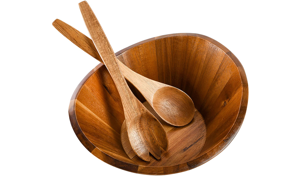 A wooden bowl with two wooden serving spoons